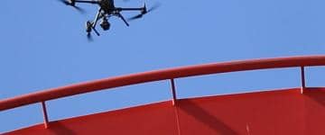 A drone performs an inspection of roller coaster track at Carowinds amusement park